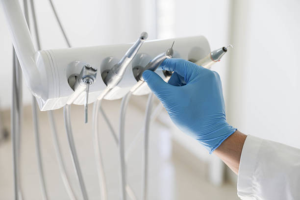 Professional Tooth Extraction technician working in St. Louis, MI